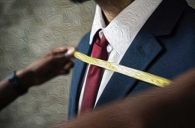 Man of colour being measured by a Black male tailor across the chest