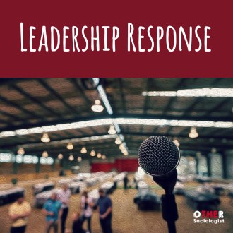 Microphone in the foreground, with people in the background of a large exhibition space