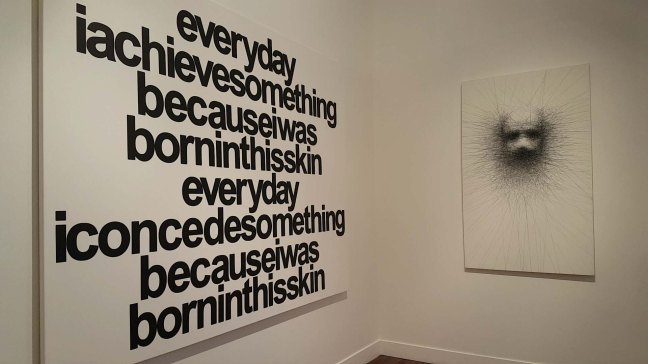 Left is word-based art that reads: 'everday I achieve something because I was born in this skin, everyday I concede something becuase I was born in this skin. Right is a drawing of various crossing lines that suggest the outline of a face that fades in focus in the centre