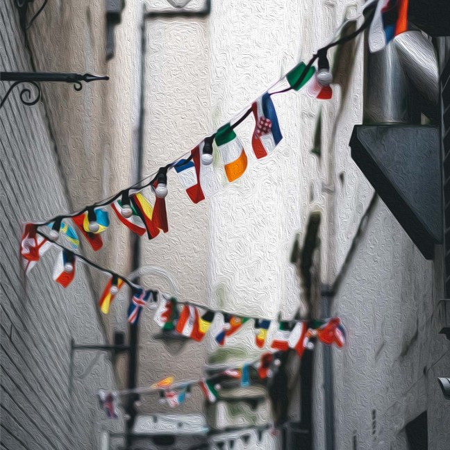 Flags from around the world hang high above an alleyway