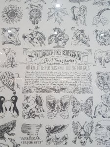 Black and white poster behind glass wth various drawings around the edges, showing animals, skulls, flowers, flags and hearts. In the centre is writing, mostly hard to read. Notably it says: Something For Everybody, by Good Time Charlie.Broadway Tattoo, Sydney