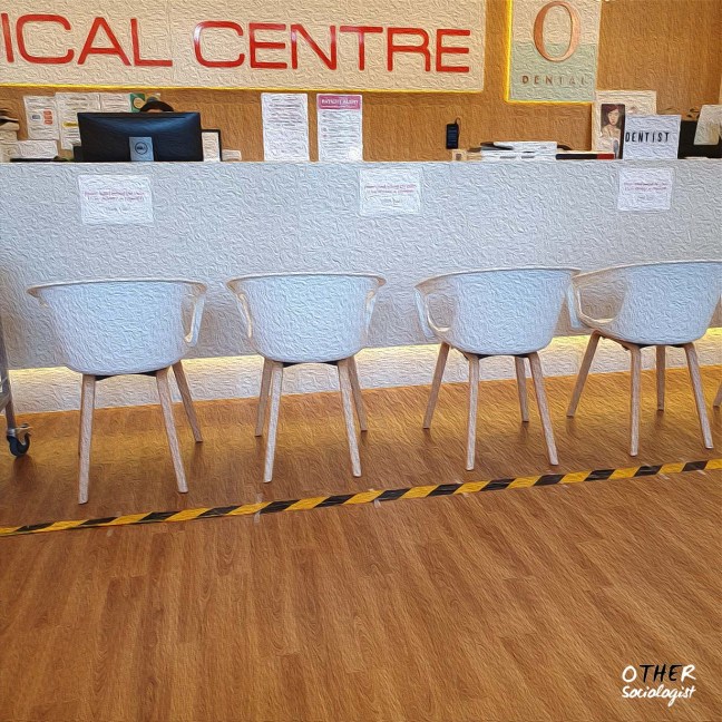Medical centre with chairs and police tape blocking off front desk