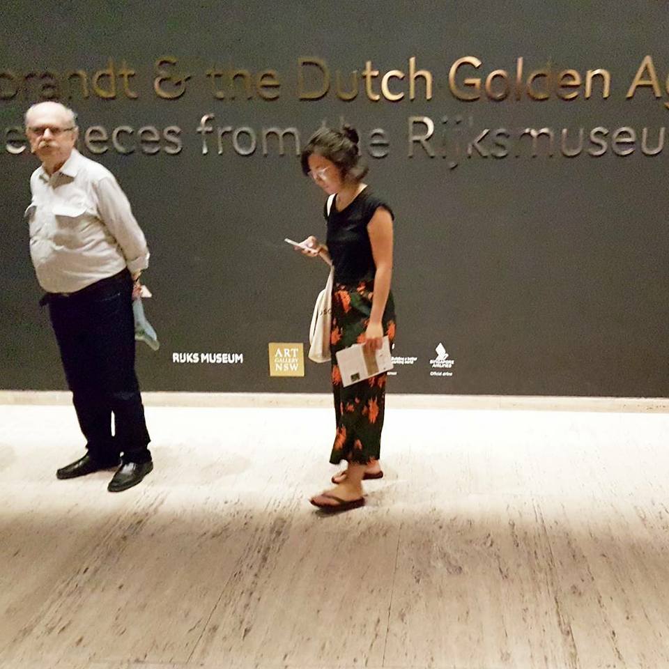 White man and Asian woman outside the exhibition